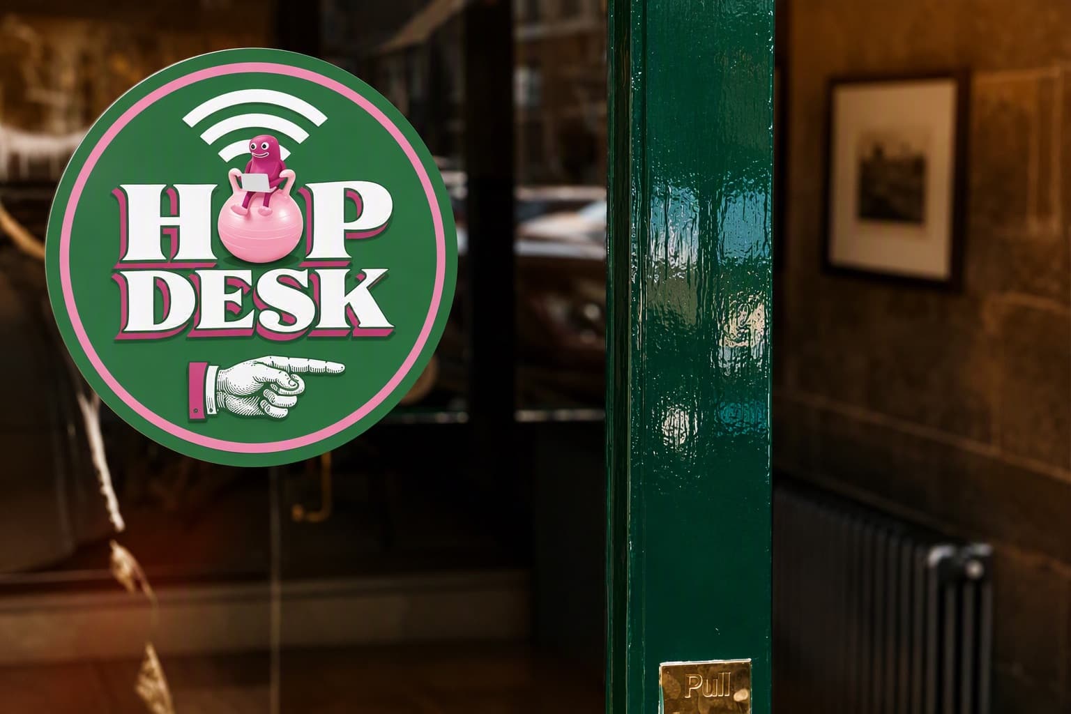 A round HopDesk sticker on a pub door, with a pointing hand showing the way in